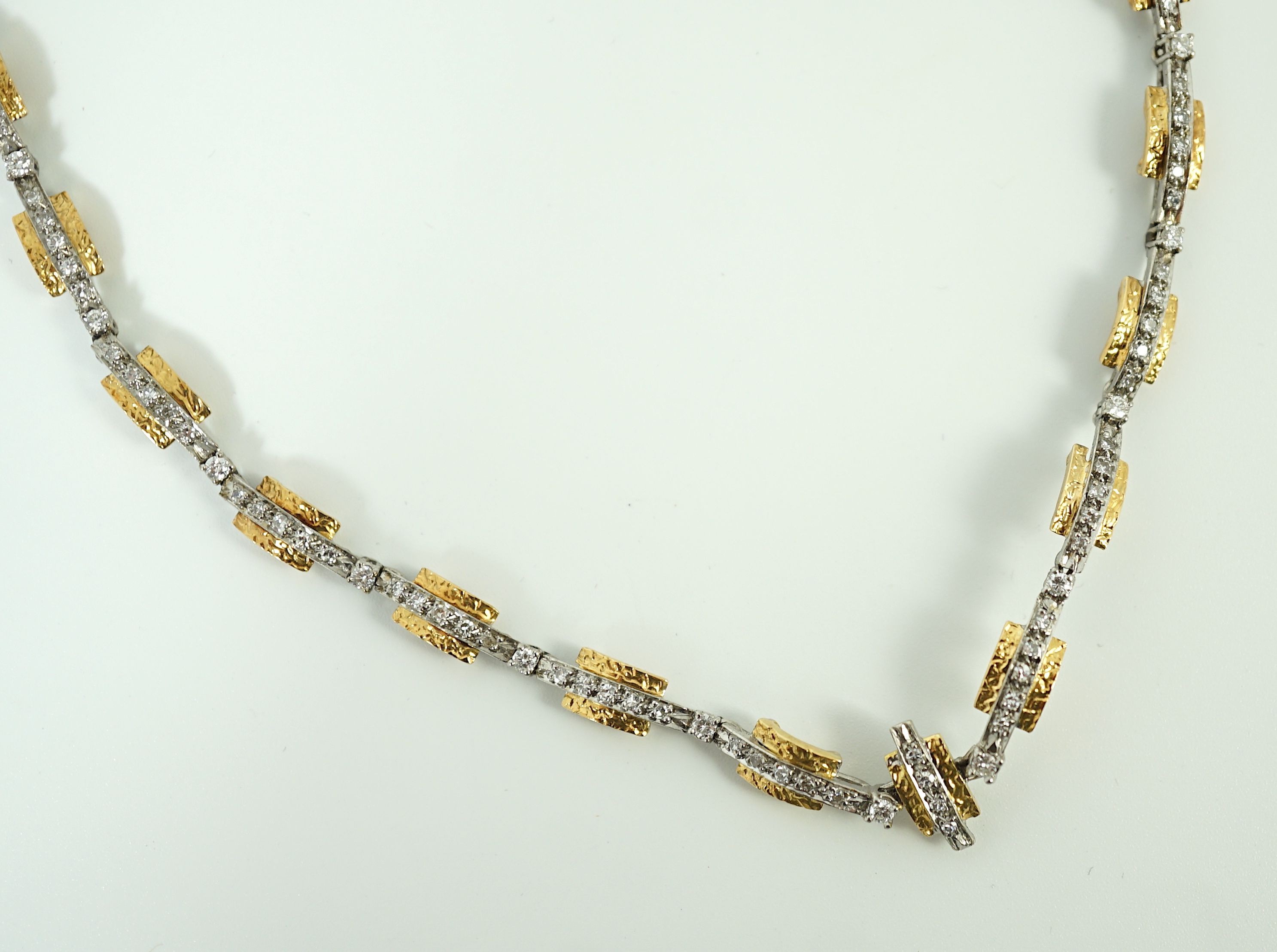 A 20th century two colour gold and diamond set necklace